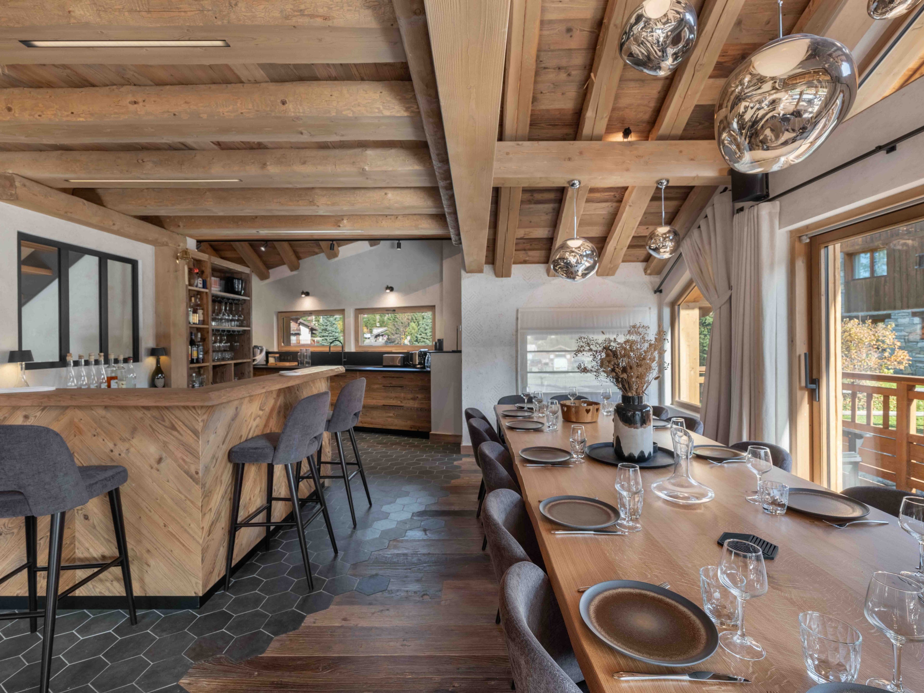Bar with high stools beside the long dining table