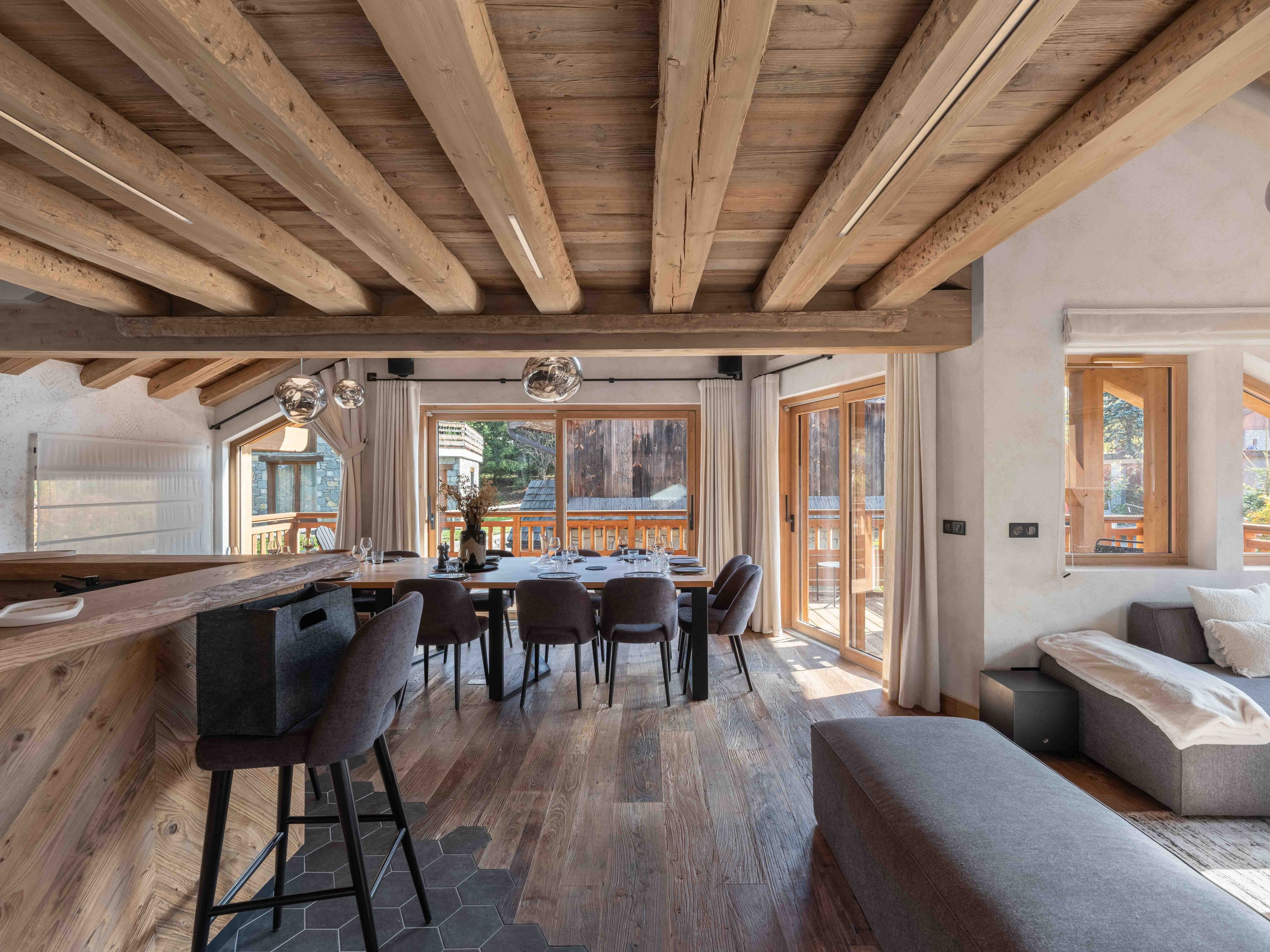 Dining room seen from the bar, with the long table and doors onto the balcony